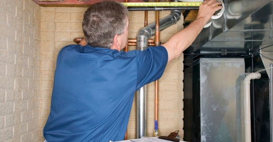 plumber measuring pipes